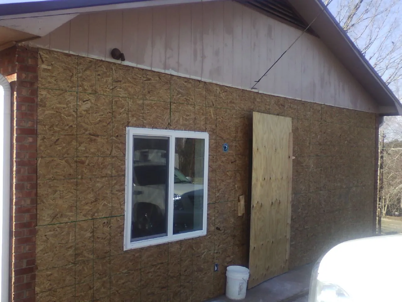OSB sheathing on a garage addition wall before siding in Bluff City